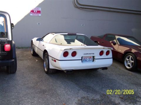 1994 Ford Bronco - A white Corvette is parked next to a Jeep and another car. The Corvette has a Washington license plate.