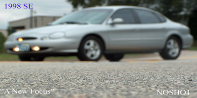 1998 Ford Taurus - Silver 1998 Ford Taurus sedan captured in a 3/4 front view, with '1998 SE' text visible on the image.