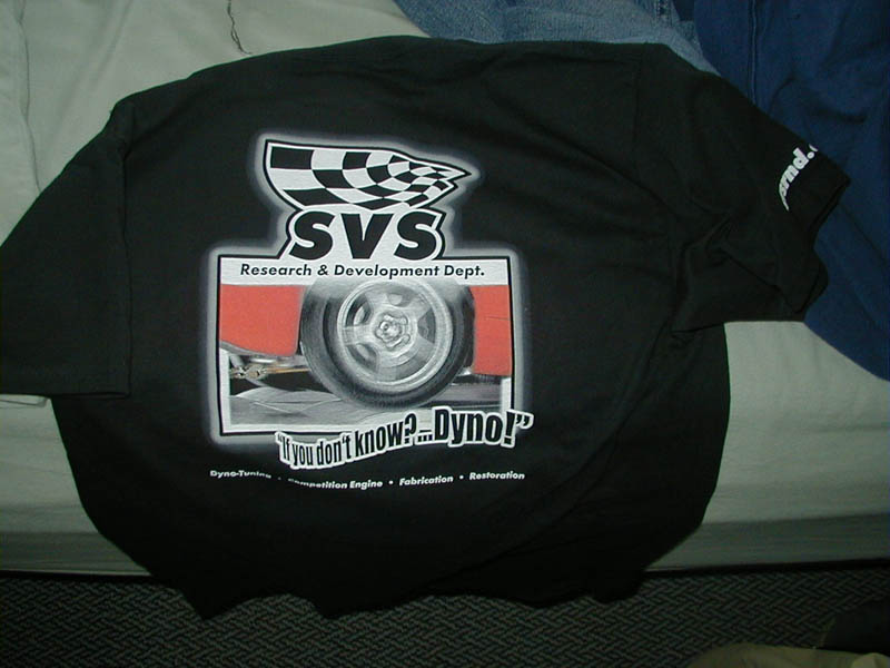 Black SVS Research and Development t-shirt with checkered flag tire graphic on a couch