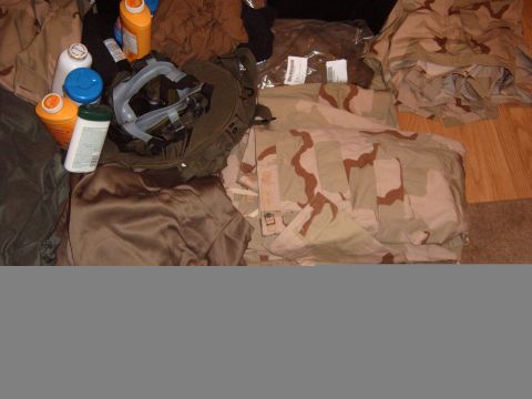 1988 Ford Bronco - Various military items including clothing and protective gear are spread out on the floor.