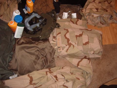 1988 Ford Bronco - Assorted military gear and cleaning supplies are spread out on the floor.