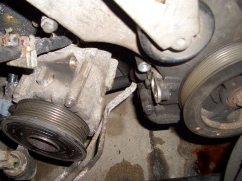 1992 Ford Crown Victoria - Engine component detail, likely a pulley system part, with visible wear and fluid stains.