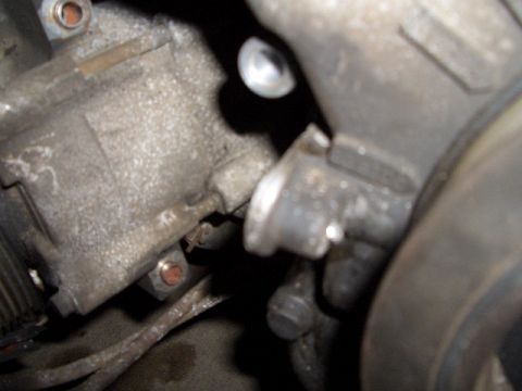 1992 Ford Crown Victoria - A detailed view of an engine component, showing mechanical connections and textured surfaces.