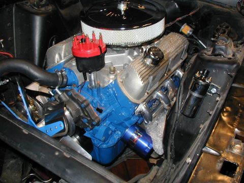 1968 Ford Mustang - Close-up view of a blue-painted Ford V8 engine, chrome valve covers and a red distributor cap.