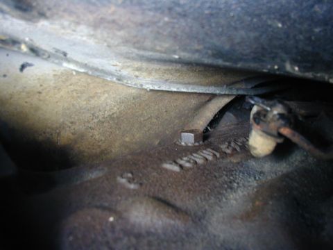 1968 Ford Mustang - A close-up view of an engine block shows some cast-in numbers and a bolt.