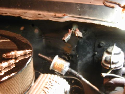 1968 Ford Mustang - Close-up view of engine components including spark plugs, an air filter, and a fuel filter.