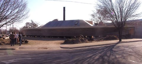 1988 Ford Bronco - A large wooden boat hull is seen on stands, appearing to be under construction.