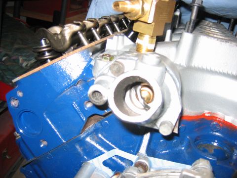 1992 Ford Bronco - Close-up of a freshly painted blue engine block with the intake manifold removed, showing the exposed valvetrain (rocker arms and valve spr…