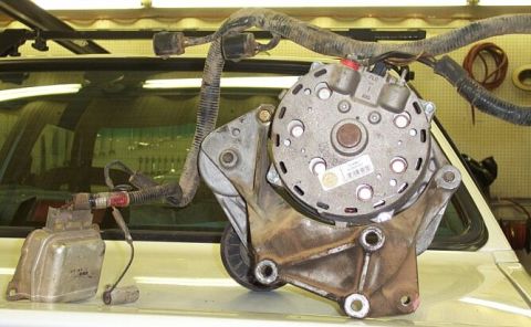 1986 Ford Ranger - Close-up of an alternator and voltage regulator assembly, likely for a vehicle's engine.