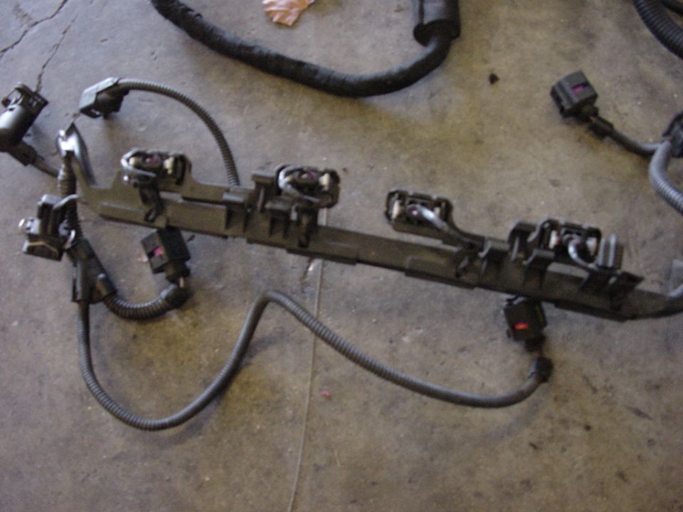 Engine wiring harness with multiple connectors and black corrugated tubing