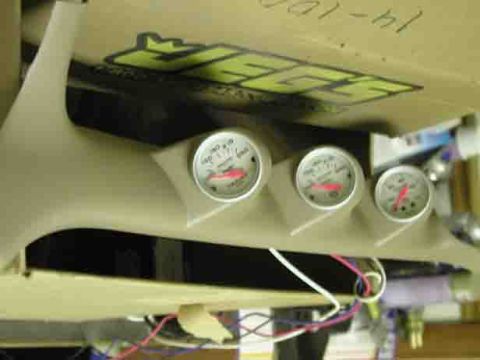 1988 Ford Bronco - A tan gauge pod with three circular gauges is mounted inside a vehicle, with wiring visible.