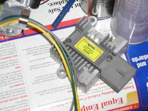 1988 Ford Bronco - Accel ignition module with yellow label and wires is shown on top of documents.