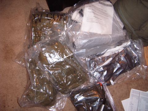 1988 Ford Bronco - Unidentified items are packaged and stored on a carpeted floor, with some documentation present.