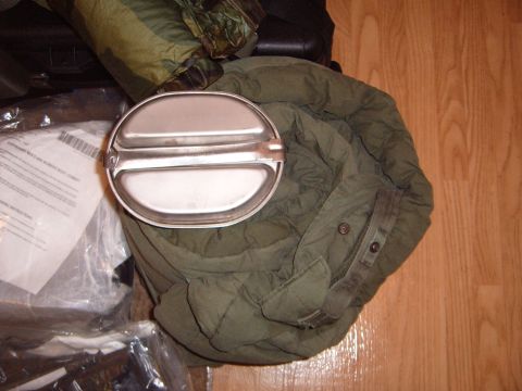 1988 Ford Bronco - Military mess kit and sleeping bag are laid out on a wooden floor.