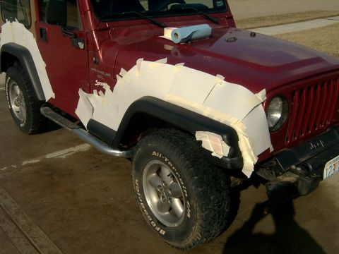 1998 Jeep TJ - 1998 Jeep TJ undergoing bodywork on the front fender and hood area.