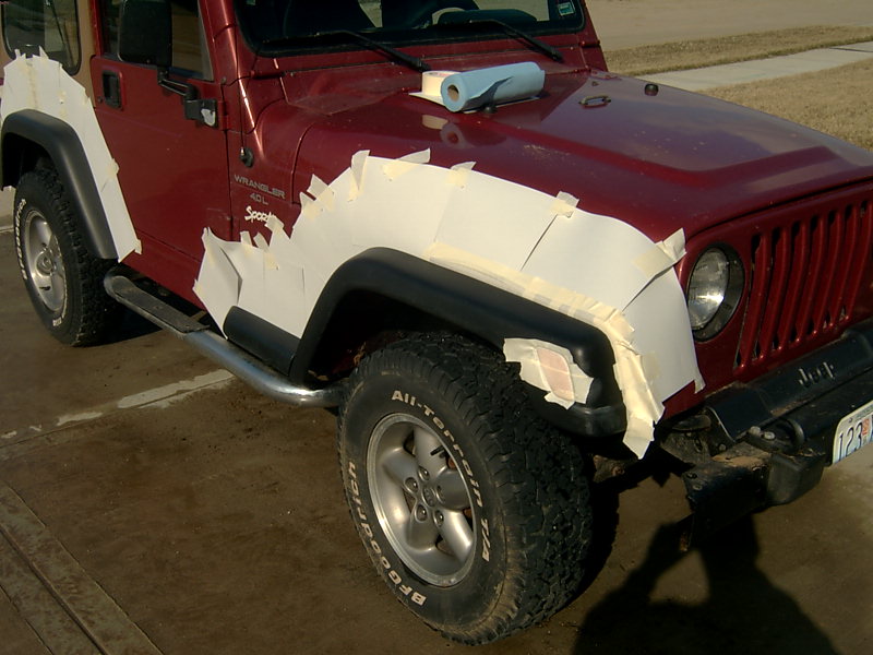 1998 Jeep TJ with masking tape and filler on front fender and hood