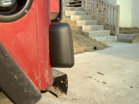 1998 Jeep TJ - Close-up of a 1998 Jeep TJ's rear quarter panel, showing the fender flare and fuel filler area.