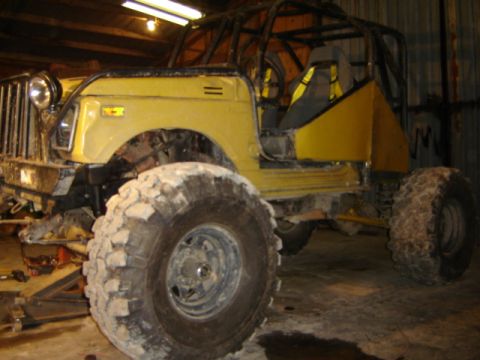 1989 Ford Bronco - This heavily modified vehicle appears to be undergoing some work in a garage setting.