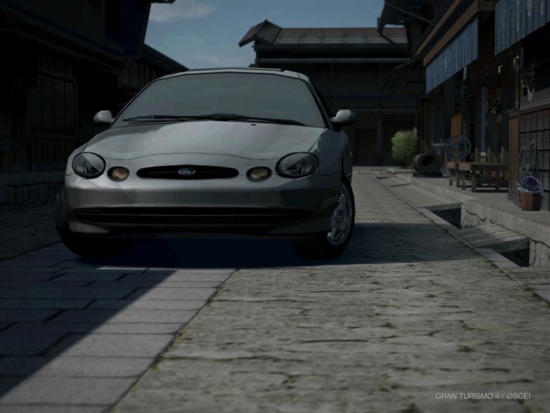 Silver sedan front view parked on cobblestone street