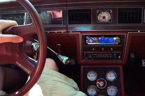 1985 Ford Crown Victoria LTD - Interior view of a car's dashboard, an aftermarket stereo and multiple gauges.