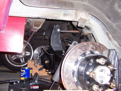 1971 Ford Mustang - Close-up view of a custom rear suspension and brake assembly, drilled rotors and aftermarket components.
