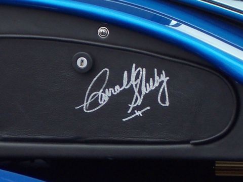 1971 Ford Mustang - A close-up view of a car's interior shows a signature on a black panel.