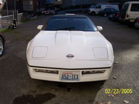 1994 Ford Bronco - Front view of a white 1994 Chevrolet Corvette with pop-up headlights and a Washington license plate.