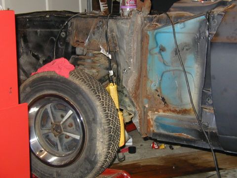 1968 Ford Mustang - This image shows a rusty car fender and wheel well, not a complete vehicle.