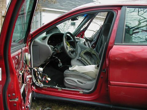 1997 Ford Taurus - Interior view of a 1997 Ford Taurus with the driver's door removed, revealing disassembled components.