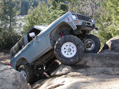 1984 Ford Bronco II - This 1984 Ford Bronco II navigates a challenging rocky terrain, demonstrating its off-road capabilities.