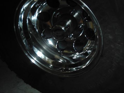 1978 Ford Bronco - Close-up of a chrome wheel and tire, with Supermotors.net branding in the corner.