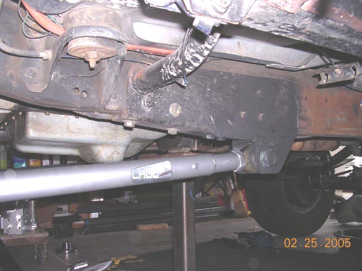 drivers side.  The cage arms mounted about 2" further back from where my other arms were, so I cut off all the old mounts below the frame.  the new mounts eliminated the hope of reusing the stock tranny crossmember