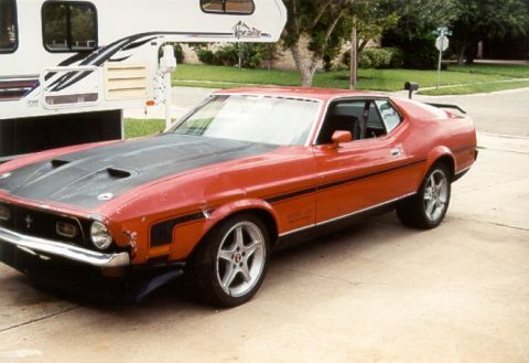 1971 Ford Mustang - This 1971 Ford Mustang Mach 1 features a distinctive black hood scoop and side stripes.