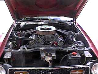 1971 Ford Mustang - Front view of a 1971 Ford Mustang's engine compartment, showing the V8 engine and associated components.