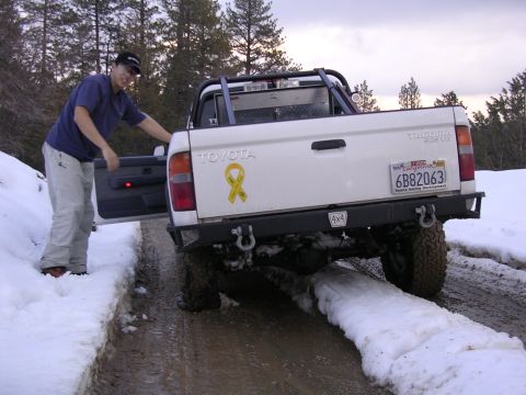 1999 Toyota Tacoma - 1999 Toyota Tacoma pickup truck with yellow ribbon sticker on tailgate, parked in snow. California license plate 6B82063.