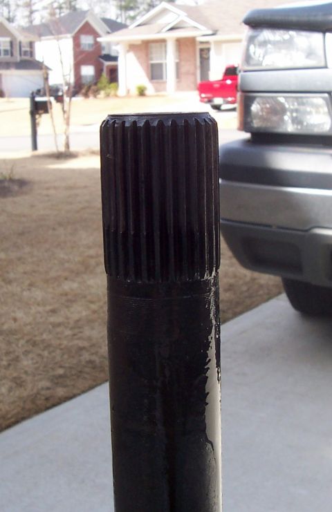 1967 Pontiac Lemans - A close-up of a splined shaft is shown with vehicles in the background.