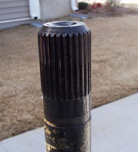 1967 Pontiac Lemans - A close-up view of a splined shaft, likely a vehicle component, with a black finish and visible teeth.