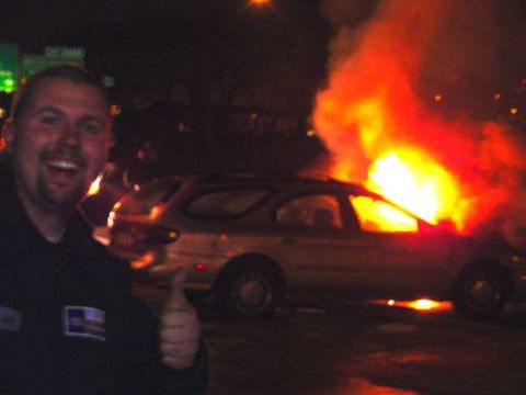 1979 Ford Bronco - Car fire at night with a man posing for the photo.
