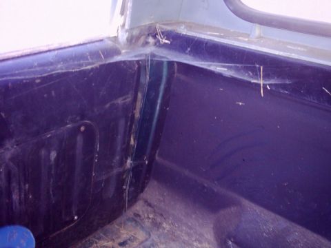 1978 Ford Bronco - The interior corner of this 1978 Ford Bronco shows signs of disuse with accumulated dust and spiderwebs.