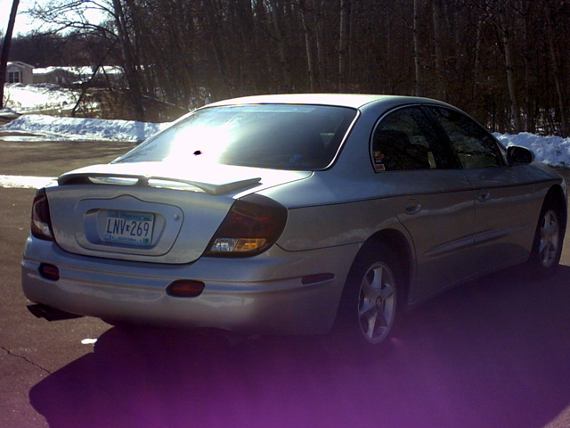 Silver sedan with a rear spoiler and a license plate reading LNV-269