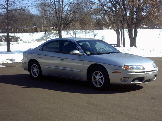 2002 Oldsmobile Aurora sedan parked outdoors in winter with snow on the ground