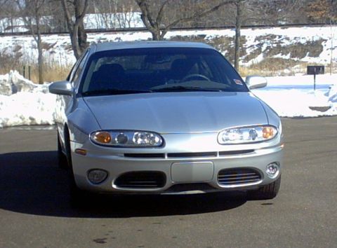 2002 Oldsmobile Aurora - A silver 2002 Oldsmobile Aurora is shown from the front on a cold, snowy day.