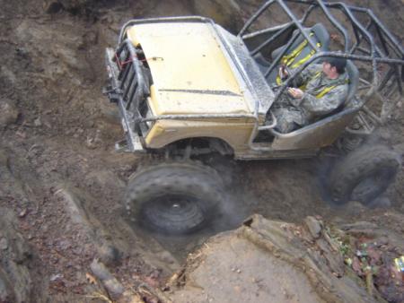 1989 Ford Bronco - Modified 1989 Ford Bronco tackles a challenging muddy hill climb.