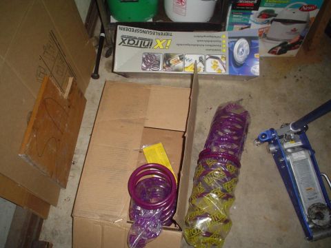 1993 Ford Taurus - Suspension springs and a floor jack are stored in a garage.