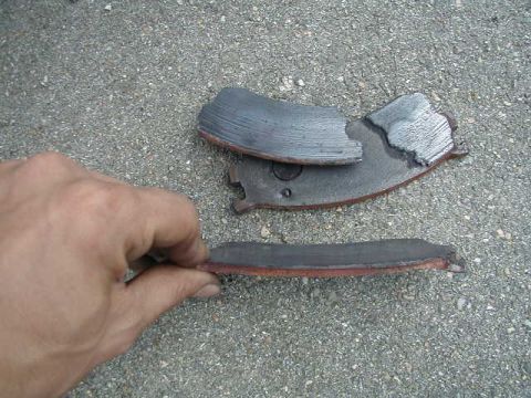 1993 Ford Probe - Worn brake pads are shown on a gravel surface, with a watermark for Supermotors.net.