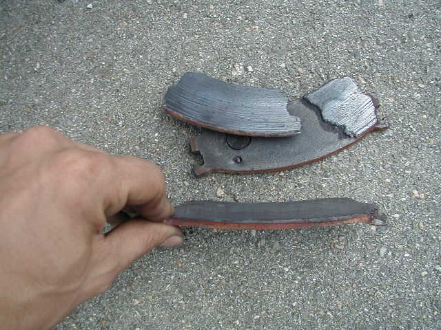 hand holding worn brake pads