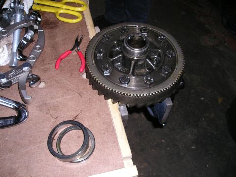 1996 Ford Bronco - Tools and a differential gear assembly are laid out on a workbench, suggesting a repair or installation process.