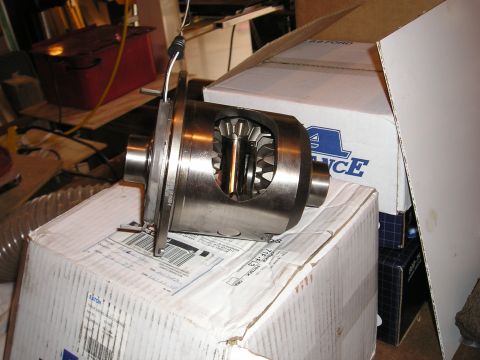 1996 Ford Bronco - A differential part is shown resting on cardboard boxes in a workshop setting.