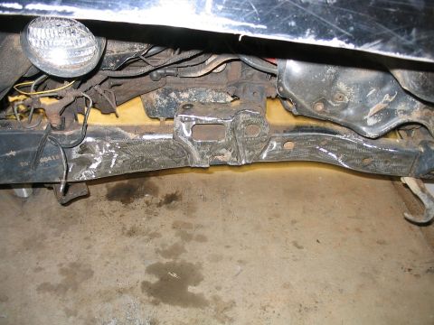 1986 Ford F-150 - Close-up of a vehicle's front frame section, showing structural components and a visible part number.
