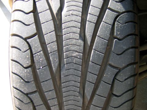 2000 Ford Crown Victoria - A detailed view of a tire's tread pattern, showing the grooves and sipes designed for traction.